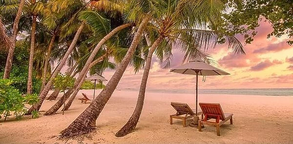 Tranquil tropical sunset scenery couple sun bed loungers, umbrella palm tree leaves. White sand sea view horizon, colorful twilight sky, calm relax