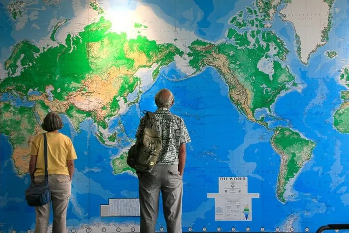 Framed Print : Travelers look at huge wall map of the World in Auckland airport New Zealand Framed Print : Travelers look at huge wall map of the World in Auckland airport New Zealand