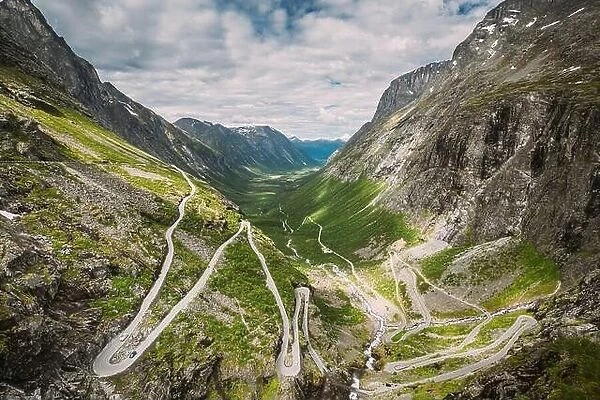 Trollstigen, Andalsnes, Norway. Cars Goes On Serpentine Mountain Road Trollstigen. Famous Norwegian Landmark And Popular Destination. Norwegian County