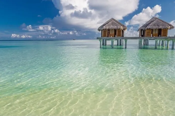 Framed Print : Tropical beach in Maldives with luxury over water bungalows or villas. Amazing sea lagoon with blue sky and clouds. Exotic travel destination Framed Print : Tropical beach in Maldives with luxury over water bungalows or villas. Amazing sea lagoon with blue sky and clouds. Exotic travel destination