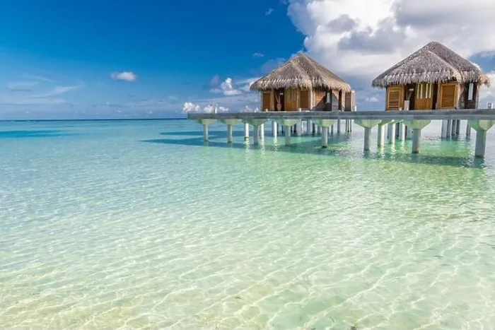 Framed Print : Tropical beach in Maldives with luxury over water bungalows or villas. Amazing sea lagoon with blue sky and clouds. Exotic travel destination Framed Print : Tropical beach in Maldives with luxury over water bungalows or villas. Amazing sea lagoon with blue sky and clouds. Exotic travel destination