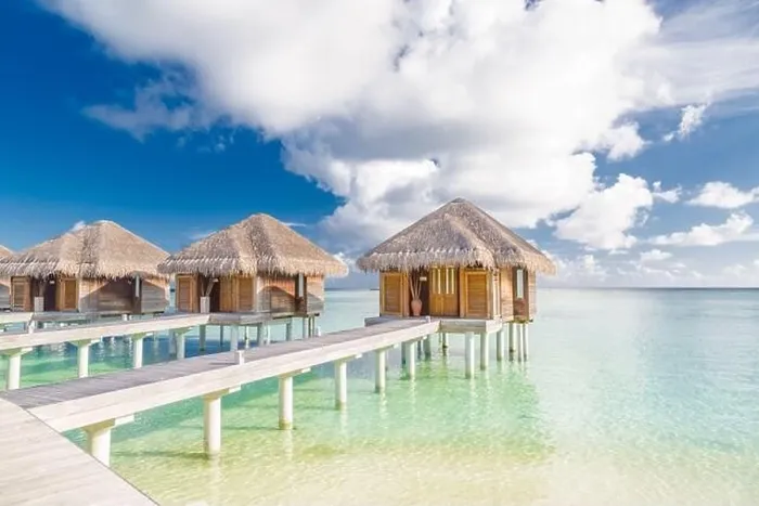 Framed Print : Tropical beach in Maldives with luxury over water bungalows or villas. Amazing sea lagoon with blue sky and clouds. Exotic travel destination