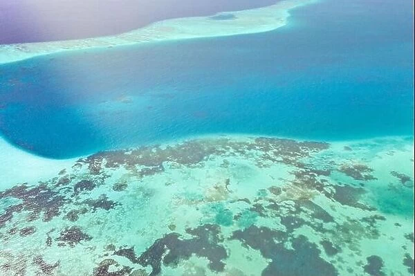 Tropical island aerial. Coral reef with turquoise lagoon. Great Barrier Reef