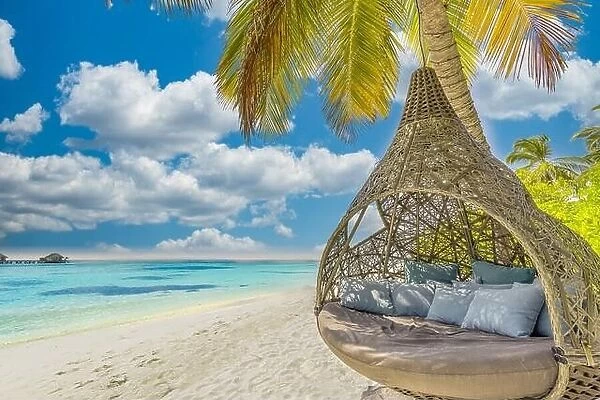 Tropical island beach as summer landscape with beach swing or hammock. Happy idyllic blue sky, sand palm tree leaves calm sea beach. Couple romance