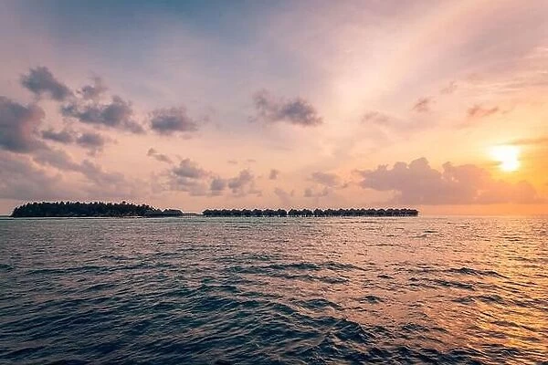Tropical island view from sea. Sunset sky clouds, peaceful nature seascape. Exotic vacation background
