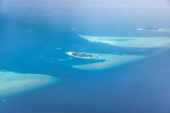Framed Print : Tropical islands and atolls in Maldives from aerial view. Famous travel destination and luxury vacation or summer holiday concept. Aerial landscape Framed Print : Tropical islands and atolls in Maldives from aerial view. Famous travel destination and luxury vacation or summer holiday concept. Aerial landscape