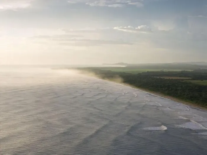 Framed Print : Tropical ocean beach coast on golden light aerial drone view