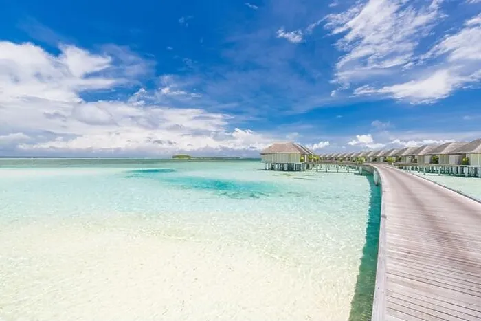 Framed Print : Tropical paradise: view of over water bungalows at a resort in the Maldives, Indian Ocean. Long jetty leading into water villas under blue tropic sky Framed Print : Tropical paradise: view of over water bungalows at a resort in the Maldives, Indian Ocean. Long jetty leading into water villas under blue tropic sky