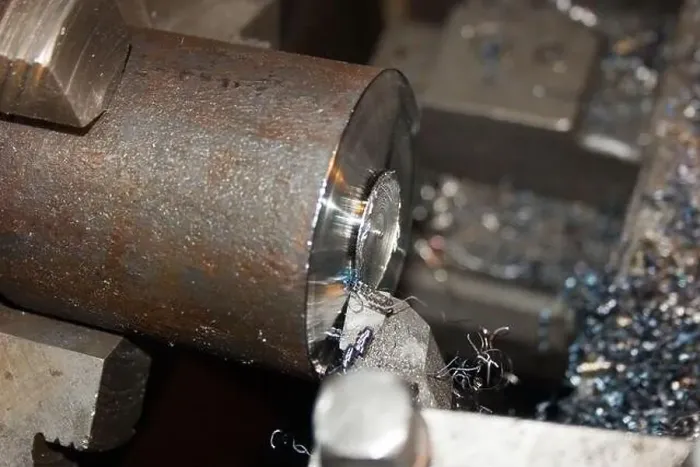 Framed Print : Turning operation. Cutting the end of a metal bar on a lathe. Close-up Framed Print : Turning operation. Cutting the end of a metal bar on a lathe. Close-up