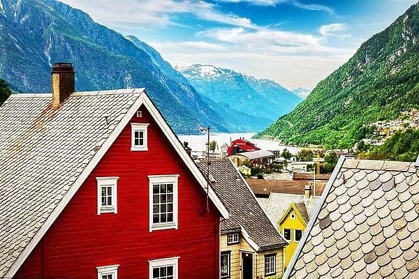 Typical norwegian houses near fjord and snowy mountains. Norway, Europe. Landscape photography
