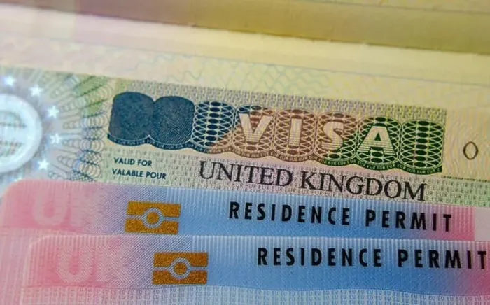 Framed Print : UK BRP cards for Tier 2 work visa placed on top of UK Business VISA sticker in the passport. Close up photo Framed Print : UK BRP cards for Tier 2 work visa placed on top of UK Business VISA sticker in the passport. Close up photo