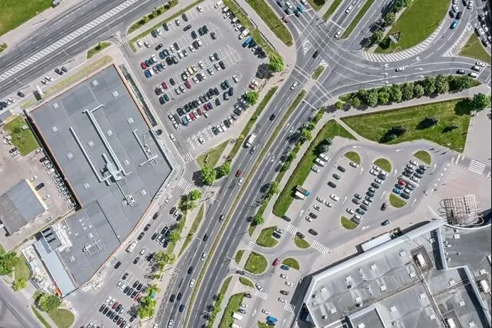 Framed Print : urban life. shopping center with parking lots and car traffic on city streets. aerial top view with drone