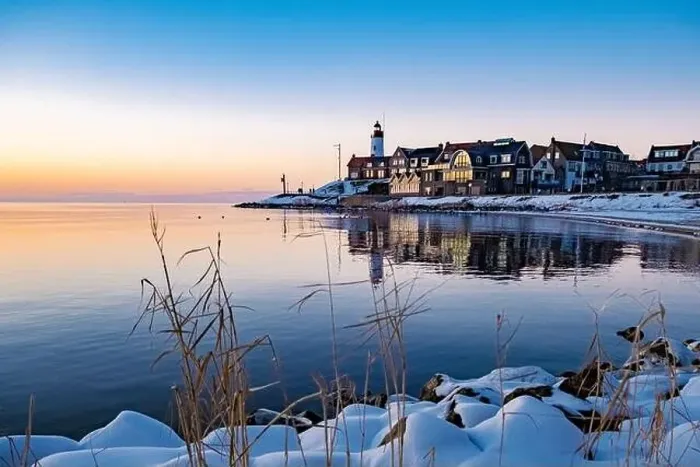 Framed Print : Urk Netherlands lighthouse during winter with snow covered coastline Framed Print : Urk Netherlands lighthouse during winter with snow covered coastline