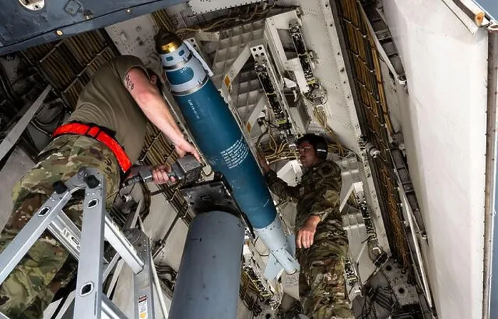 Framed Print : U.S. Airmen assigned to the 34th Expeditionary Bomb Squadron load a joint direct attack munition at Andersen Air Force