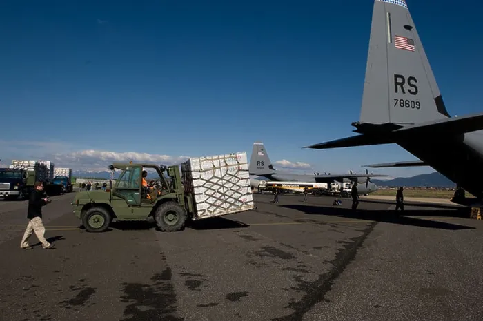 Framed Print : U.S. Airmen Load Blankets, Tarps, and Water Containers Onto Aircraft Framed Print : U.S. Airmen Load Blankets, Tarps, and Water Containers Onto Aircraft