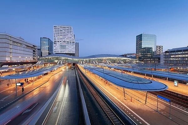 Utrecht, Netherlands cityscape over train station platforms at dawn