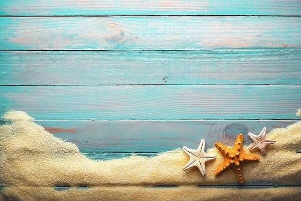 Vacations and summer time concept with starfishs on a turquoise wooden table with sand. Sea and ocean vacation background