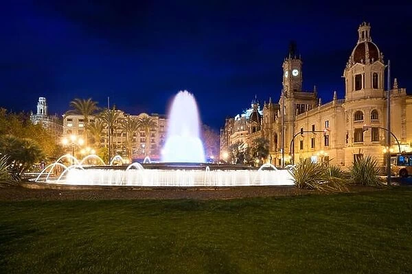 Valencia City Hall on Plaza del Ayuntamiento with colorful fountain in Valencia, Spain