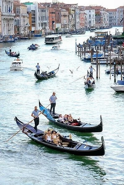 Venice, Italy - August 7, 2014: gondolas and boats on venetian Grand Canal