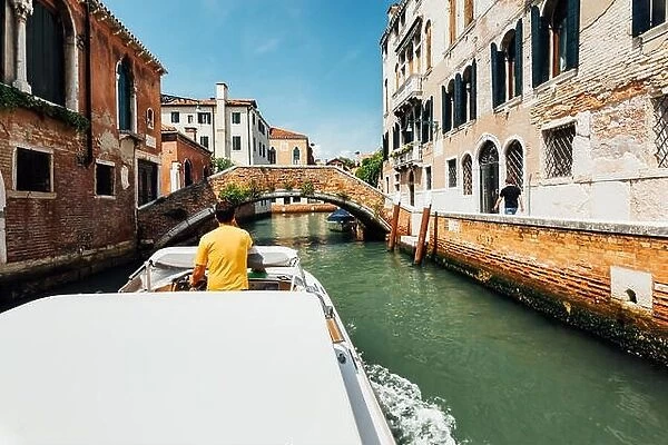 Venice, Italy - August 8, 2014: trip to old venetian canal on motor boat