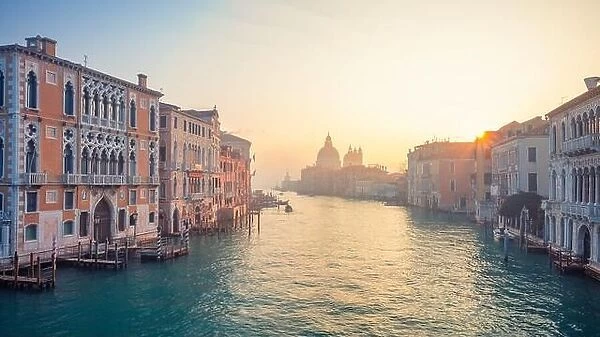 Venice, Italy. Cityscape image of Grand Canal in Venice, with Santa Maria della Salute Basilica in the background at winter sunrise