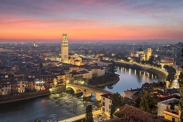 Verona, Italy town skyline on the Adige River at dusk