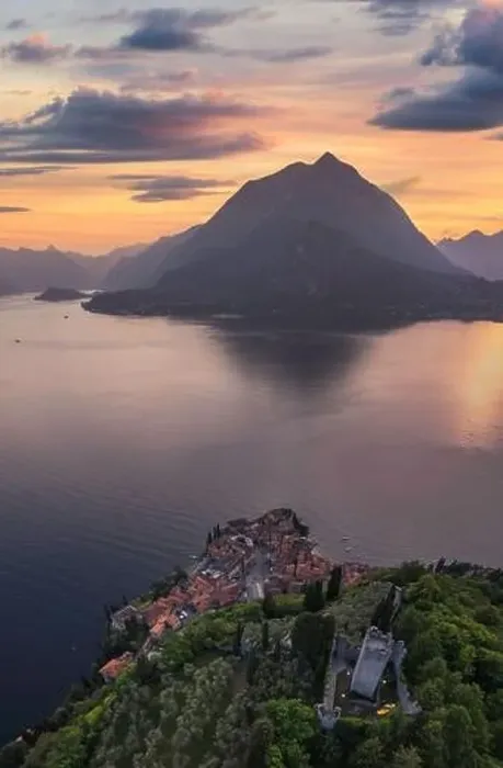 Framed Print : Vertical panoramic aerial view of Vezio Castle with Varenna village and mountains in background during summer sunset Framed Print : Vertical panoramic aerial view of Vezio Castle with Varenna village and mountains in background during summer sunset