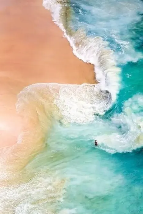 Framed Print : View from above, stunning aerial view of a person relaxing on a beautiful beach bathed by a turquoise sea during sunset Framed Print : View from above, stunning aerial view of a person relaxing on a beautiful beach bathed by a turquoise sea during sunset
