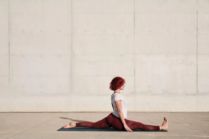 Framed Print : Side view of barefooted Woman with closed eyes in sportswear doing yoga in monkey pose on mat training alone on street Framed Print : Side view of barefooted Woman with closed eyes in sportswear doing yoga in monkey pose on mat training alone on street