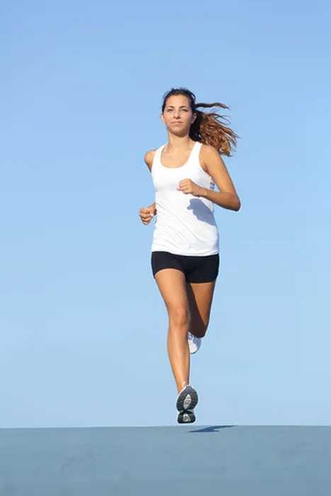 Framed Print : Front view of a beautiful sportswoman running towards camera with the blue sky in the background Framed Print : Front view of a beautiful sportswoman running towards camera with the blue sky in the background