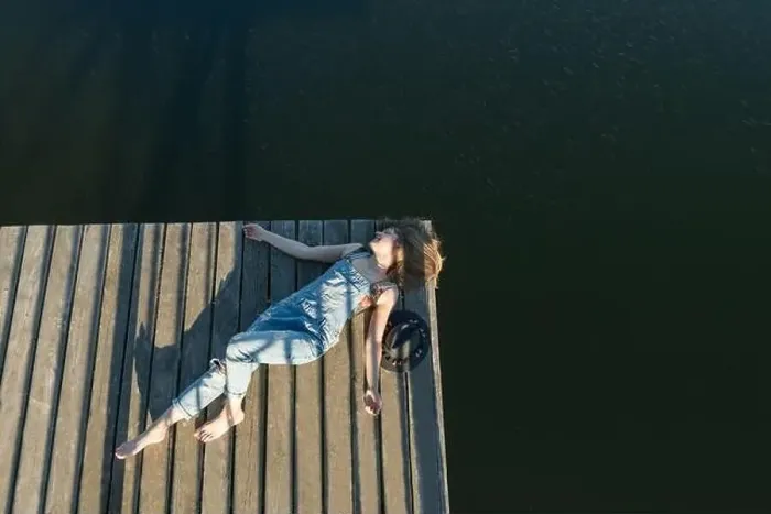 Framed Print : Top view of beautiful Woman in black swimsuit and hat lying down on wooden pier of lake on clear blue sky Framed Print : Top view of beautiful Woman in black swimsuit and hat lying down on wooden pier of lake on clear blue sky