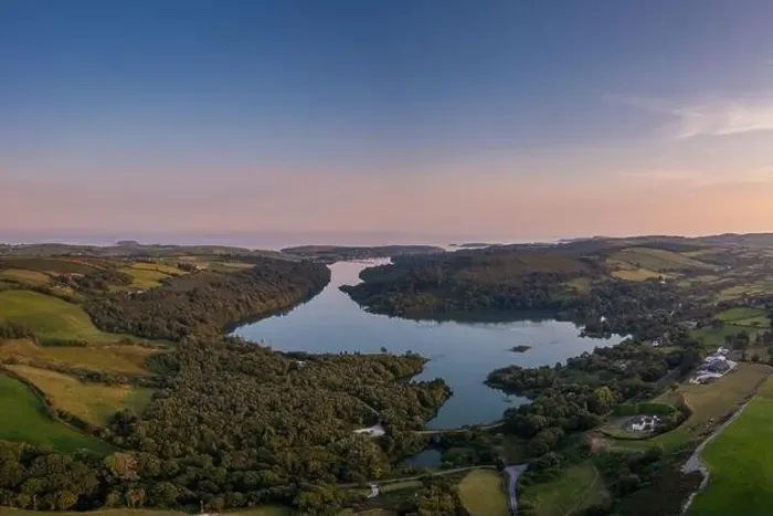 Framed Print : A view of Castlehaven Bay and Rineen Woods in West Cork in warm evening light Framed Print : A view of Castlehaven Bay and Rineen Woods in West Cork in warm evening light