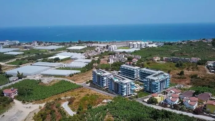 Framed Print : View from a drone flight to the resort area. Clip. View of the sea and the area of hotels and houses with green fields Framed Print : View from a drone flight to the resort area. Clip. View of the sea and the area of hotels and houses with green fields