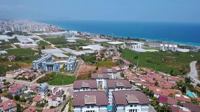 Framed Print : View from a drone flight to the resort area. Clip. View of the sea and the area of hotels and houses with green fields Framed Print : View from a drone flight to the resort area. Clip. View of the sea and the area of hotels and houses with green fields