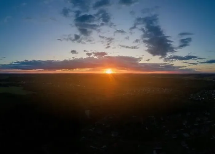 Framed Print : View from drone, panorama orange sky and gray clouds, sun at sunset Framed Print : View from drone, panorama orange sky and gray clouds, sun at sunset