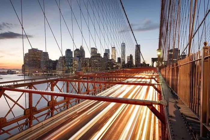 Framed Print : The view of the Financial District in New York City behind traffic on the Brooklyn Bridge after sunset Framed Print : The view of the Financial District in New York City behind traffic on the Brooklyn Bridge after sunset
