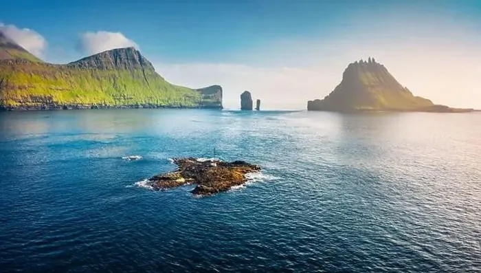 Framed Print : View from flying drone. Misty summer scene of Faroe Islands and Tindholmur cliffs on background Framed Print : View from flying drone. Misty summer scene of Faroe Islands and Tindholmur cliffs on background