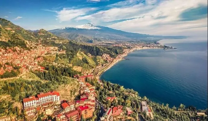 Framed Print : View from flying drone of Taormina town and Etna volcano on background Framed Print : View from flying drone of Taormina town and Etna volcano on background
