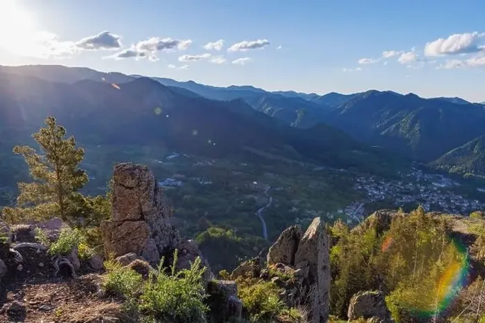 Framed Print : View from high rock to old village town of Smolyan with green meadows for cattle walking and ancient houses Framed Print : View from high rock to old village town of Smolyan with green meadows for cattle walking and ancient houses