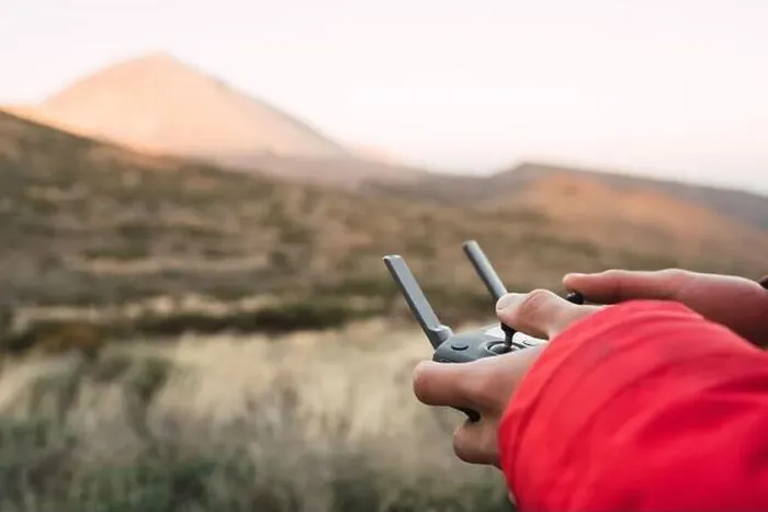 Framed Print : Side view of human holding joystick on land near top of mountain Teide in Tenerife, Canary Islands, Spain
