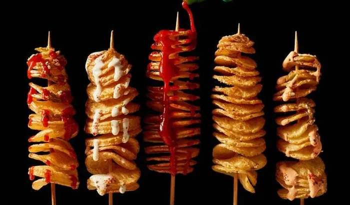 Framed Print : Top view layout of yummy crispy deep fried tornado potatoes on skewers with mayo and ketchup on black background Framed Print : Top view layout of yummy crispy deep fried tornado potatoes on skewers with mayo and ketchup on black background