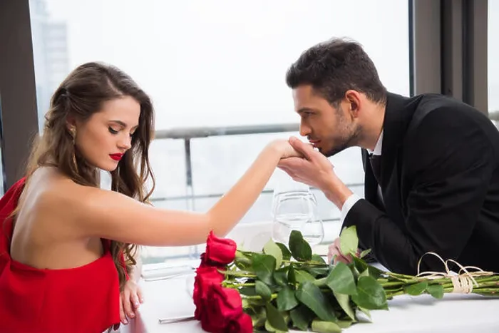 Framed Print : side view of man kissing girlfriends hand during date on st valentine day in restaurant Framed Print : side view of man kissing girlfriends hand during date on st valentine day in restaurant