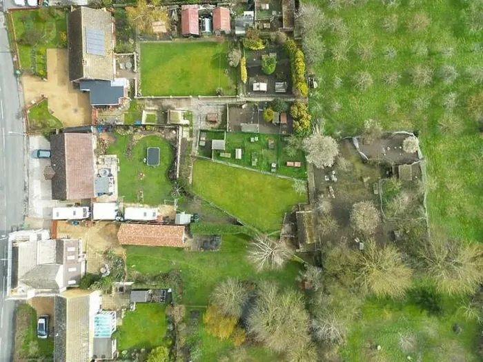 Framed Print : Top down view of a mixture of old and modern houses and bungalows seen at the edge of an East Anglian village Framed Print : Top down view of a mixture of old and modern houses and bungalows seen at the edge of an East Anglian village