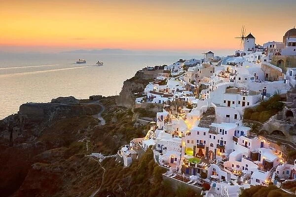View of Oia Town and windmills at sunset time, Oia, Santorini Island, Greece