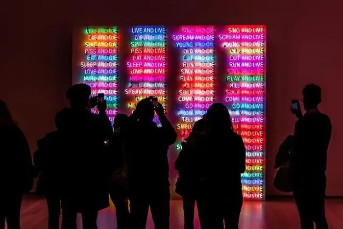 Framed Print : A back view of people taking photos of illuminated neon signs at a museum in New York Framed Print : A back view of people taking photos of illuminated neon signs at a museum in New York