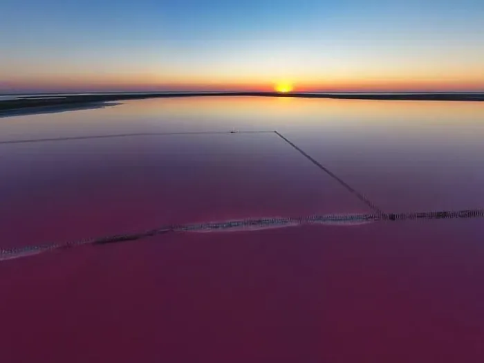 Framed Print : Top view of a shiny salty pink lake and a path along it Framed Print : Top view of a shiny salty pink lake and a path along it