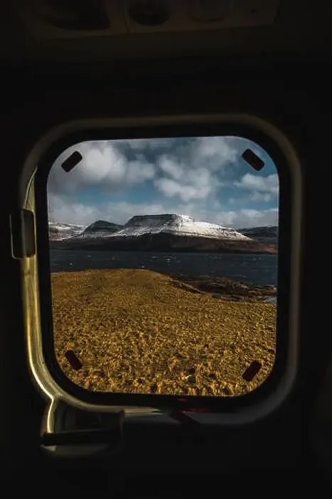 Framed Print : View onto the snow-covered shore of Faroese island Streymoy through a helicopter window taken on Koltur during an early Framed Print : View onto the snow-covered shore of Faroese island Streymoy through a helicopter window taken on Koltur during an early