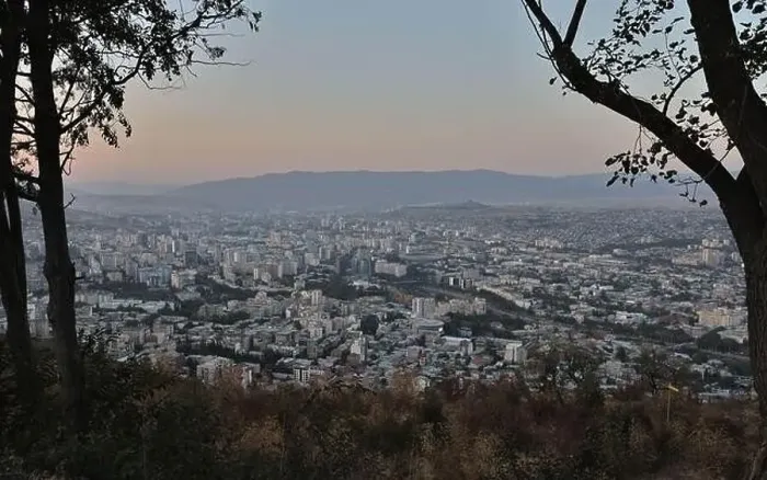 Framed Print : View of Tbilisi City from the mountain, Mtatsminda park, on the sunset throw the trees Framed Print : View of Tbilisi City from the mountain, Mtatsminda park, on the sunset throw the trees