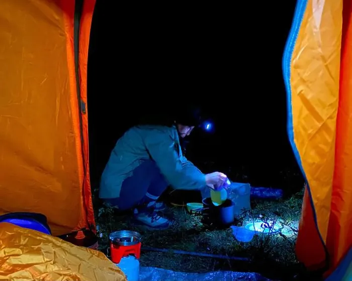 Framed Print : View from a tourist tent at night on a traveler girl with a lantern cooking food in a saucepan. Framed Print : View from a tourist tent at night on a traveler girl with a lantern cooking food in a saucepan.