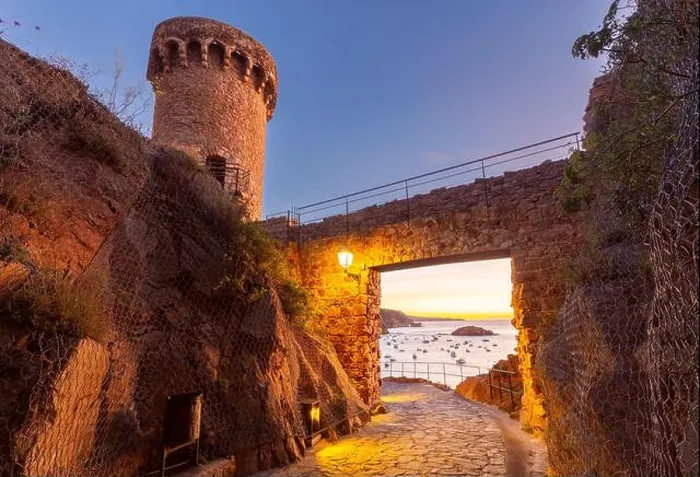 Framed Print : View of a tower and stone gateway of Tossa de Mar Castle overlooking the Mediterranean Sea at sunrise Framed Print : View of a tower and stone gateway of Tossa de Mar Castle overlooking the Mediterranean Sea at sunrise